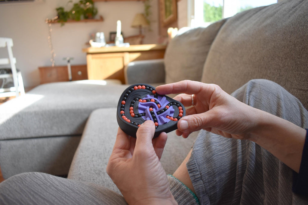 Handheld two-color mechanical puzzle, designed as a brainteaser and fidget toy, with interlocking parts. - andEleven - The Taurus (2-Color)
