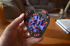 Handheld two-color mechanical puzzle brainteaser with interconnected purple and black tracks and red beads for fidgeting. - andEleven - The Taurus (2-Color)