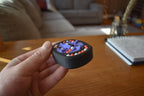Black round mechanical puzzle with colorful bead brainteaser held in hand, designed for fidgeting. - andEleven - The Infinity (3-Color)