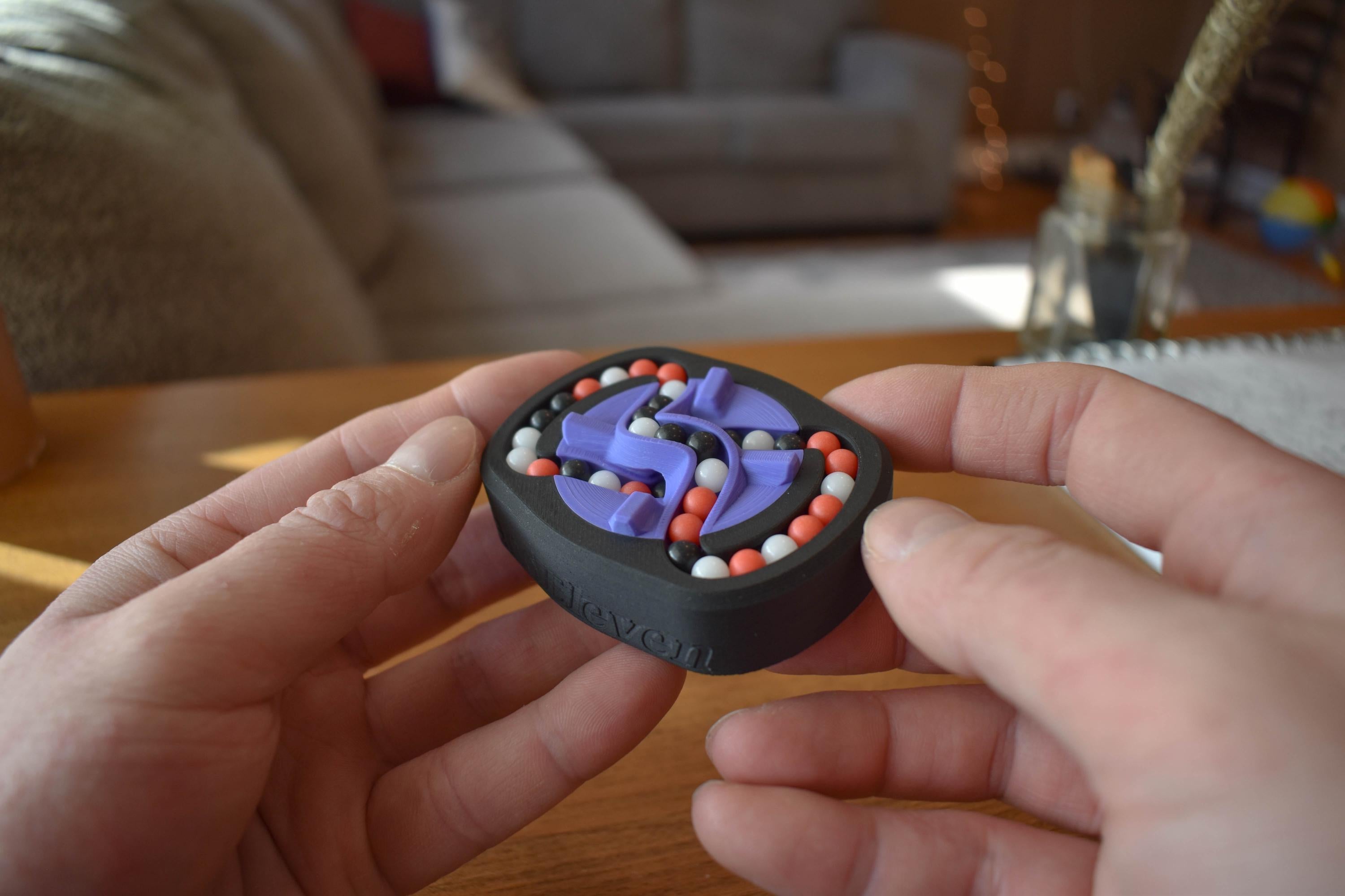 Compact three-color mechanical puzzle featuring interconnected purple, red, and white beads for fidget and brainteaser use. - andEleven - The Infinity (3-Color)