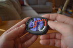 Compact black mechanical puzzle with interlocking tracks and red, white, and purple beads for brainteaser fidget play. - andEleven - The Infinity (3-Color)