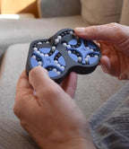 Two-color mechanical puzzle with interlocking gears held in hands, a brainteaser and fidget toy. - andEleven - The Figure-Eight (2-Color)
