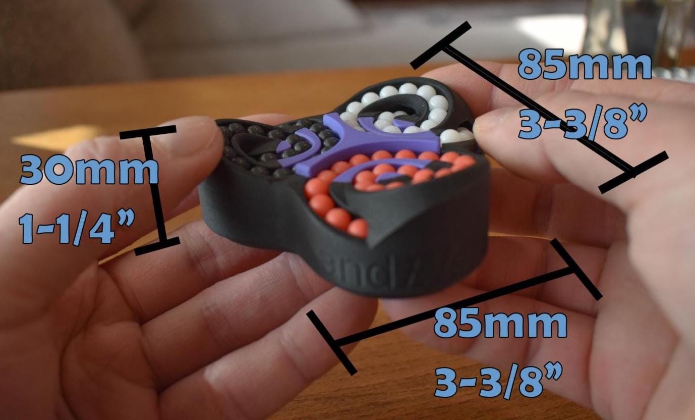 Triangular black mechanical puzzle with colorful gears, handheld brainteaser and fidget toy. - andEleven - The Triad