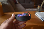 Compact round mechanical puzzle in black and purple, designed as a fidget brainteaser held in hand. - andEleven - The Taurus (2-Color)