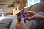 Hands holding The Taurus mechanical puzzle in black and purple, a brainteaser fidget toy. - andEleven - The Taurus (2-Color)