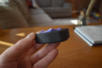 Black and purple compact mechanical puzzle brainteaser fidget held in hand on wooden table. - andEleven - The Infinity (2-Color)