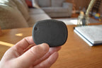 Black and gray compact mechanical puzzle fidget held in hand on wooden table background. - andEleven - The Infinity (2-Color)