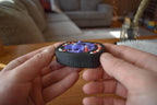 Compact black mechanical puzzle with blue and orange pieces held for fidget and brainteaser use. - andEleven - The Infinity (3-Color)