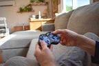 Two-tone blue and black mechanical puzzle held as a fidget brainteaser on a couch. - andEleven - The Figure-Eight (2-Color)