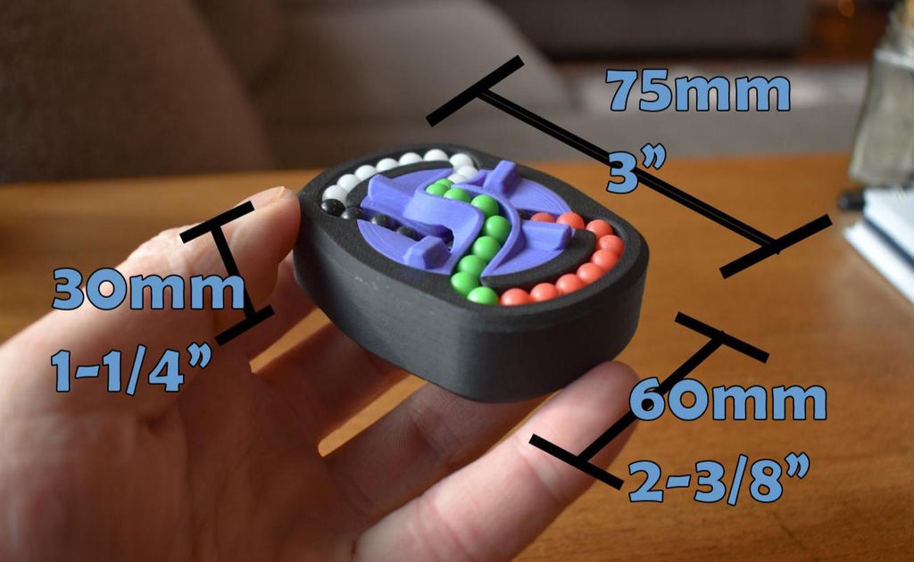 Compact black mechanical puzzle with colorful interlocking pieces held in hand, brainteaser and fidget toy. - andEleven - The Infinity (4-Color)
