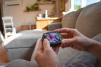 Compact colorful mechanical puzzle fidget held in hands, designed as a brainteaser with interlocking pieces. - andEleven - The Infinity (4-Color)