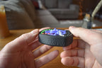 Compact black and gray mechanical puzzle fidget held in hands with colorful interlocking pieces, brainteaser toy. - andEleven - The Infinity (4-Color)