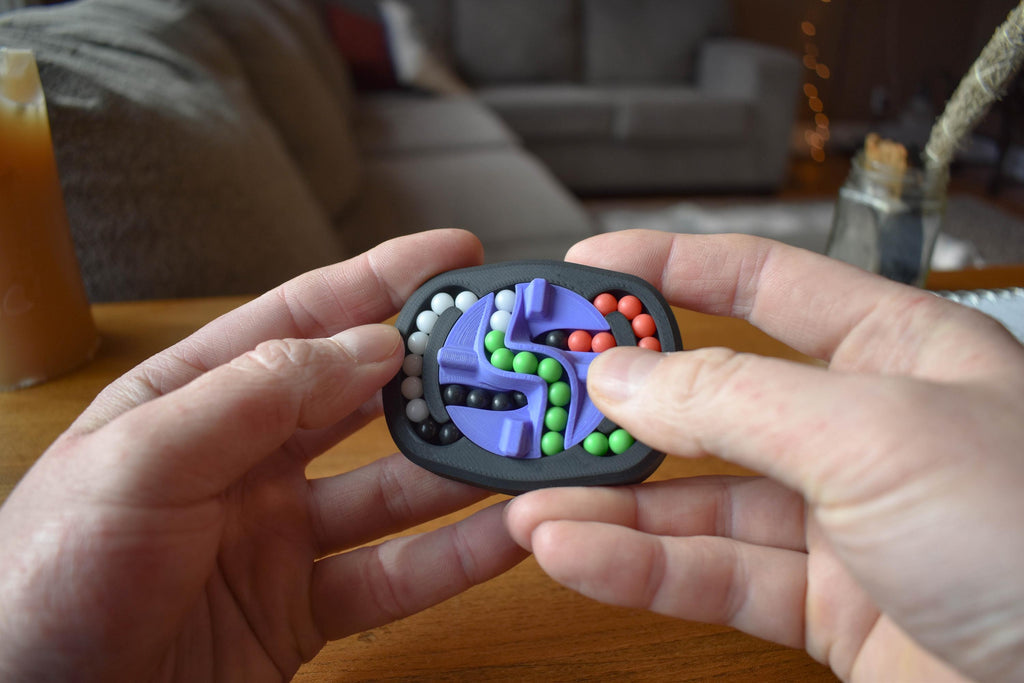 Small handheld mechanical puzzle with colorful movable beads in black frame, brainteaser fidget toy. - andEleven - The Infinity (4-Color)