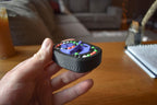 Compact black mechanical puzzle with colorful rotating dials held in hand, brainteaser fidget toy. - andEleven - The Infinity (4-Color)