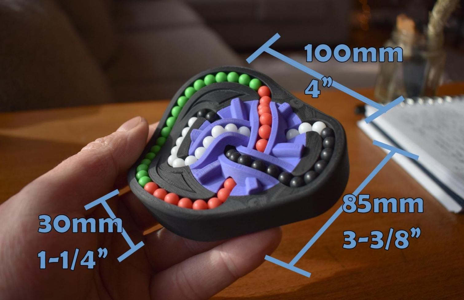 Colorful mechanical puzzle with interlocking pieces and dimensions, held in hand as a brainteaser fidget toy. - andEleven - The Taurus (4-Color)