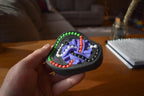 Handheld Taurus mechanical puzzle brainteaser in black with green, red, and purple tracks for fidgeting. - andEleven - The Taurus (4-Color)