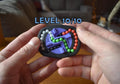 Compact black mechanical puzzle with colorful interlocking loops, a brainteaser and fidget toy held in hands. - andEleven - The Infinity (4-Color)
