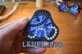 Blue and black triangular mechanical puzzle brainteaser with white beads held in hand, fidget toy level 4/10. - andEleven - The Delta (2-Color)