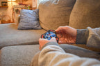 Hands holding The Delta 3-color mechanical puzzle brainteaser, cozy living room background. - andEleven - The Delta (3-Color)