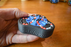 Black mechanical puzzle with blue and orange beads, labeled The Delta, handheld brainteaser fidget toy. - andEleven - The Delta (3-Color)