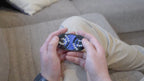 A person trying to solve the product by cycling the balls through the tracks, and turning the center rotor. The rotor makes a satisfying snap is it clicks in to place.
