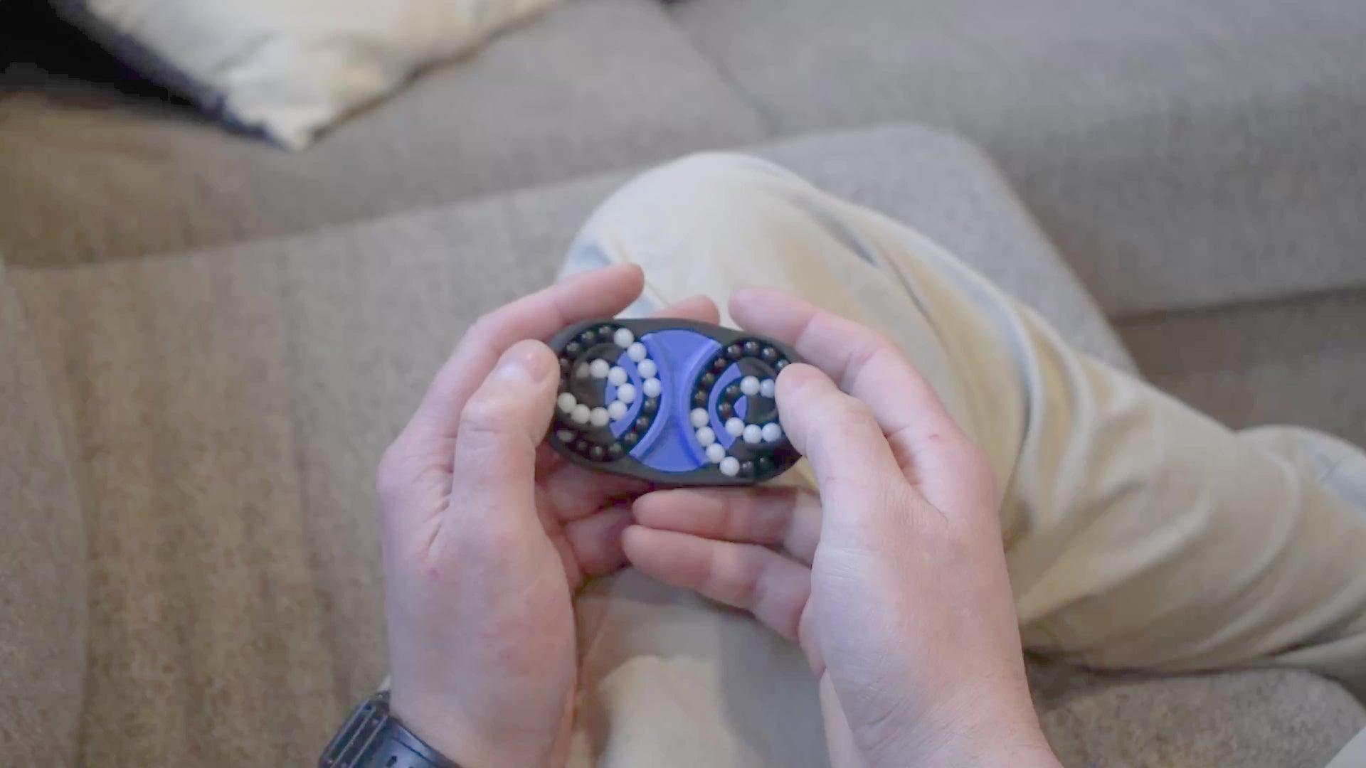 A person trying to solve the product by cycling the balls through the tracks, and turning the center rotor. The rotor makes a satisfying snap is it clicks in to place.
