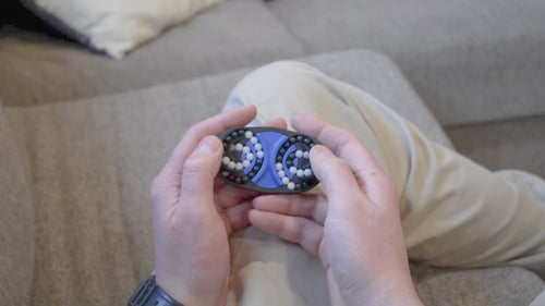 A person trying to solve the product by cycling the balls through the tracks, and turning the center rotor. The rotor makes a satisfying snap is it clicks in to place.