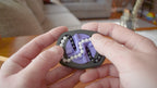 A person trying to solve the product by cycling the balls through the tracks, and turning the center rotor. The rotor makes a satisfying snap is it clicks in to place.