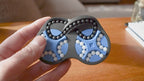 A person trying to solve the product by cycling the balls through the tracks, and turning the center rotor. The rotor makes a satisfying snap is it clicks in to place.