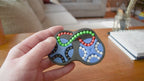 A person trying to solve the product by cycling the balls through the tracks, and turning the rotors. The rotors make a satisfying snap as they clickin to place.
