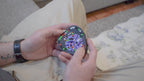 A person trying to solve the product by cycling the balls through the tracks, and turning the center rotor. The rotor makes a satisfying snap is it clicks in to place.
