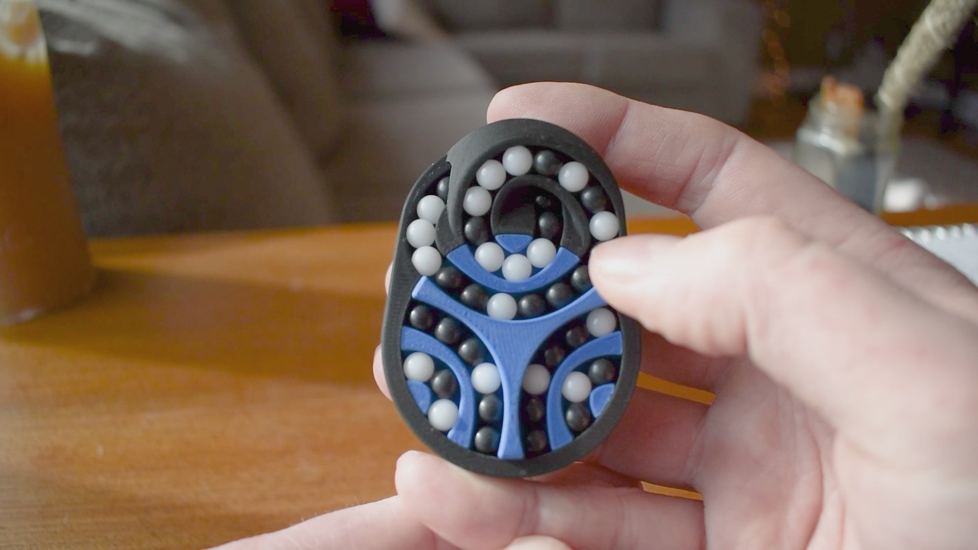 A person trying to solve the product by cycling the balls through the tracks, and turning the center rotor. The rotor makes a satisfying snap is it clicks in to place.