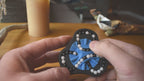 A person trying to solve the product by cycling the balls through the tracks, and turning the center rotor. The rotor makes a satisfying snap is it clicks in to place.