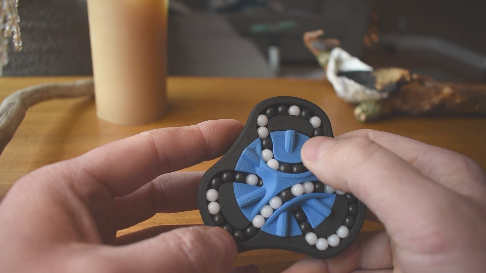 A person trying to solve the product by cycling the balls through the tracks, and turning the center rotor. The rotor makes a satisfying snap is it clicks in to place.