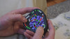 Close up interactions of several intriguing mechanical puzzles which feature balls moving through tracks and a rotating center 